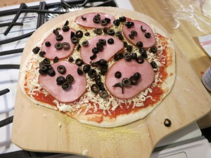 Pizza decorated and ready to go into the oven.